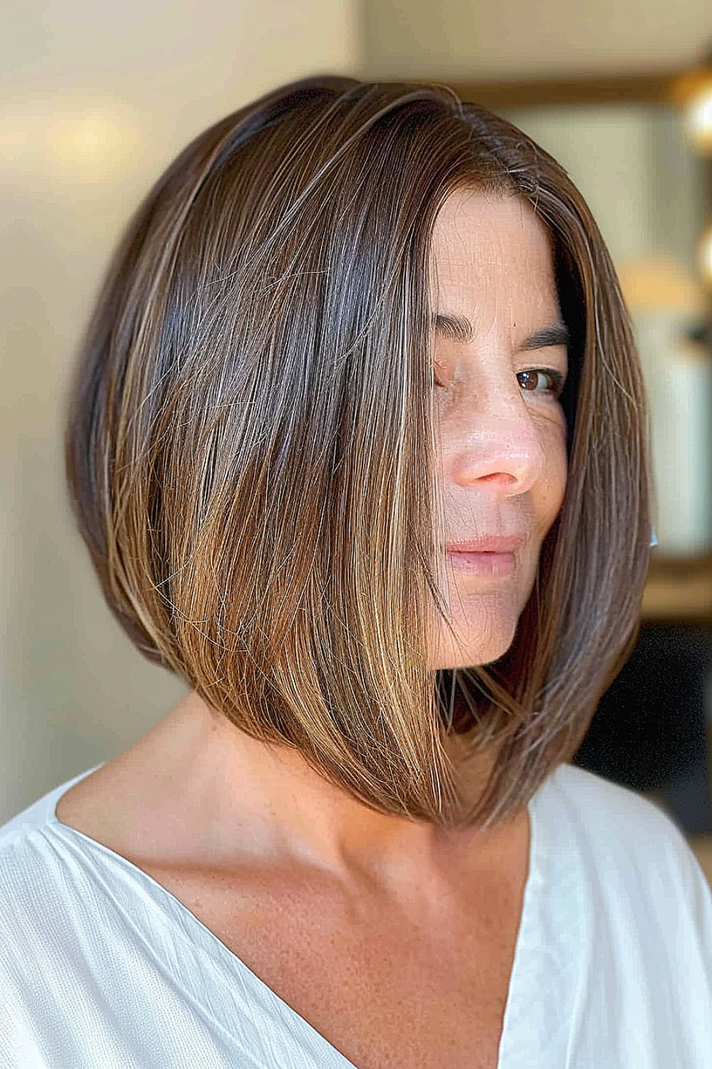 Woman with an angled lob haircut and subtle highlights