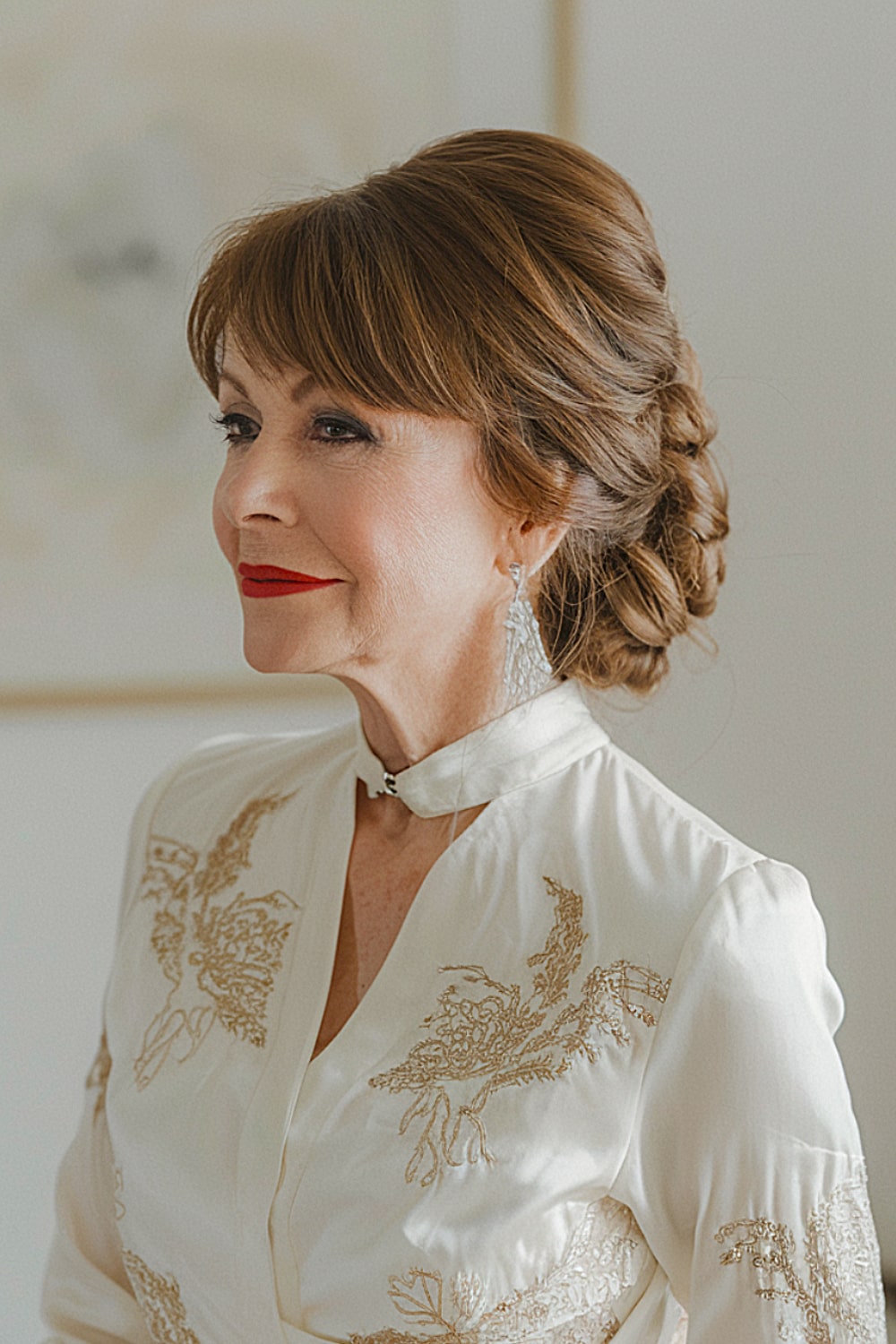 Classic updo with side swept bangs for women over 50