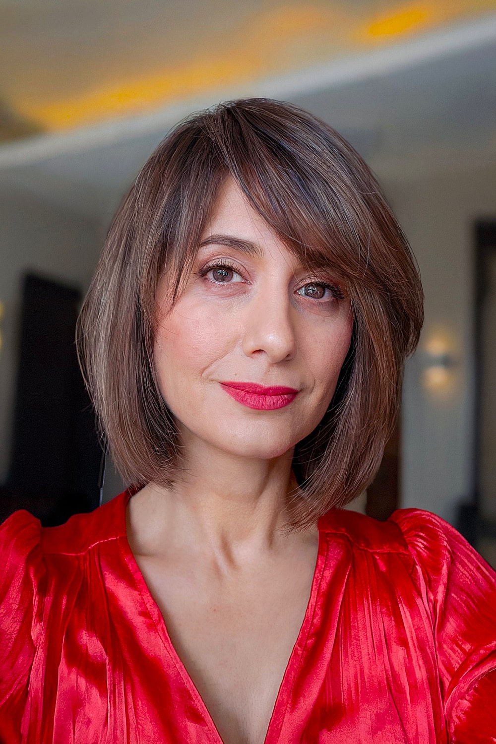 Short bob with angled bangs and shadow root