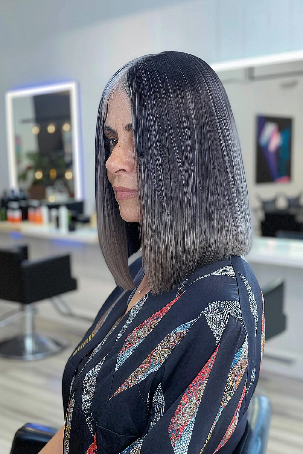 Sleek angled lob with dark roots and silver tips